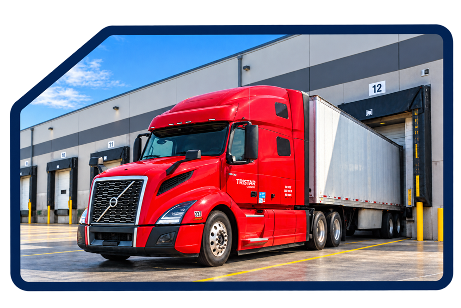 Red TriStar Global semi-truck with dry van trailer backed into a warehouse loading dock.